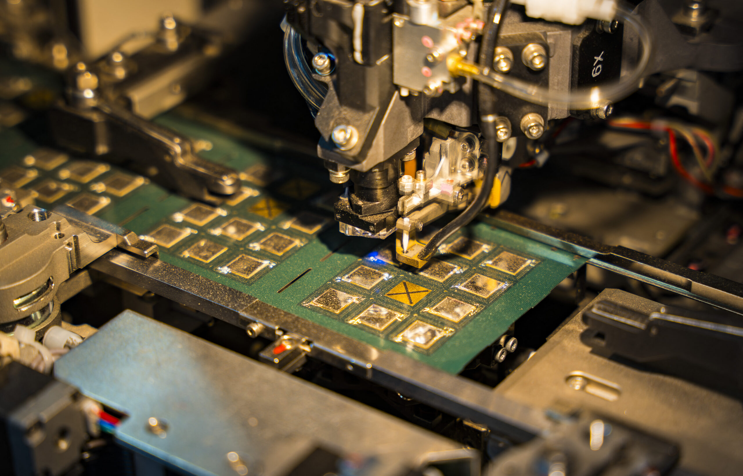 A robotic machine manufactures a semiconductor chip at a stall to show investors during The Advantage Assam 2.0 Investment Summit in Guwahati, India, on February 25, 2025.